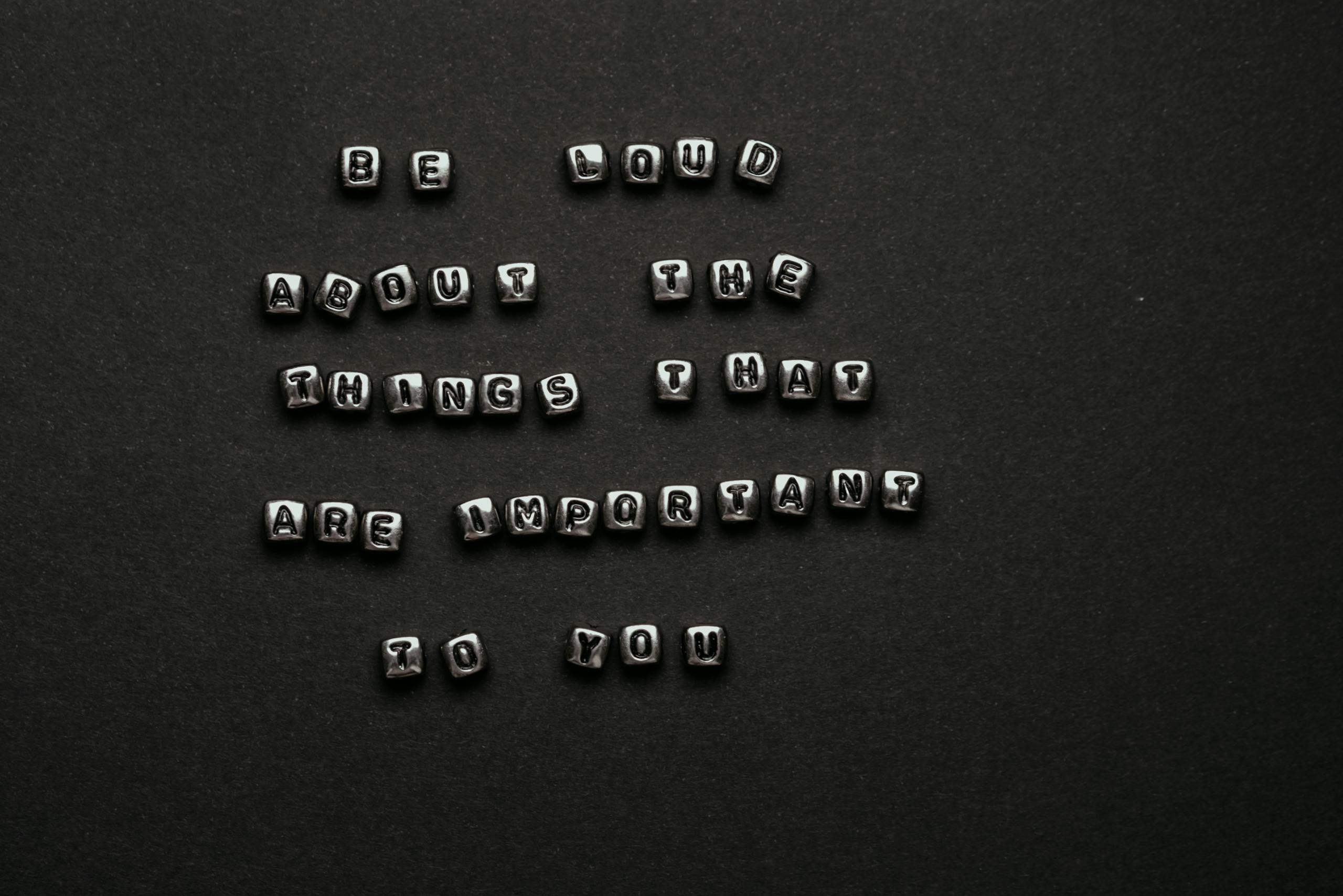 Photo by Polina ⠀ Monochrome alphabet cubes form an inspiring quote on a dark background, ideal for motivation and typography projects.